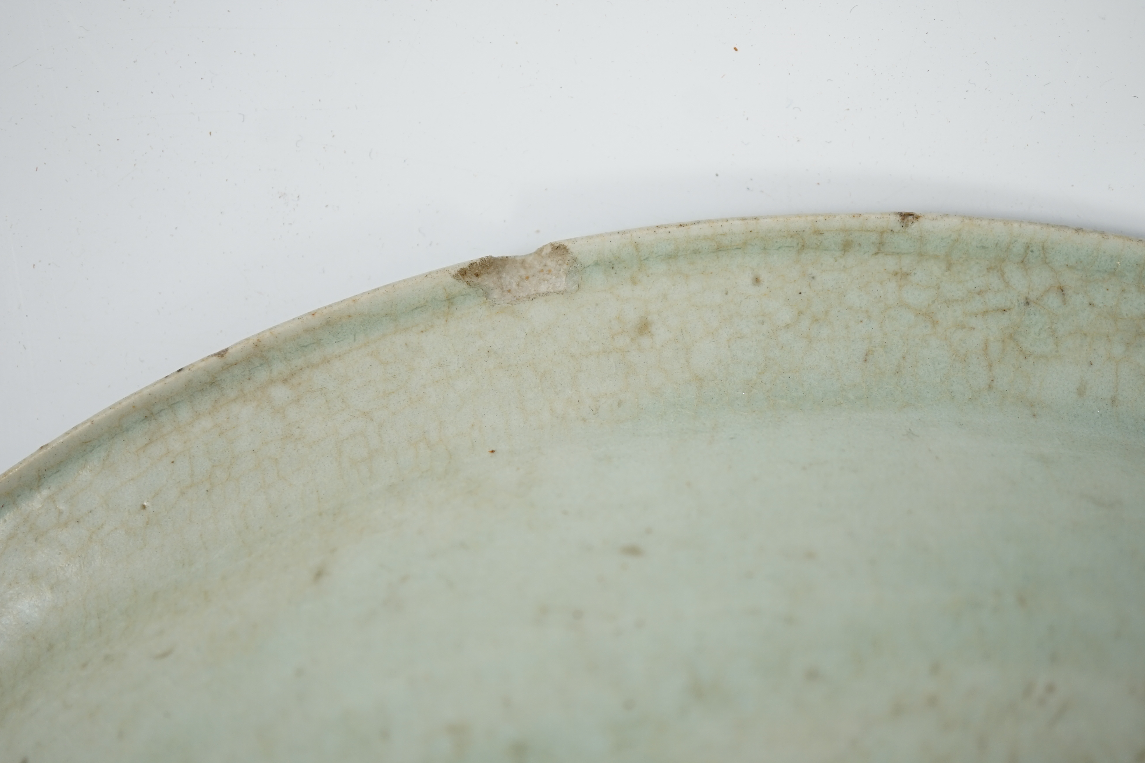 A Chinese Longquan celadon dish, Yuan-Ming dynasty, 13th/14th century, some faults